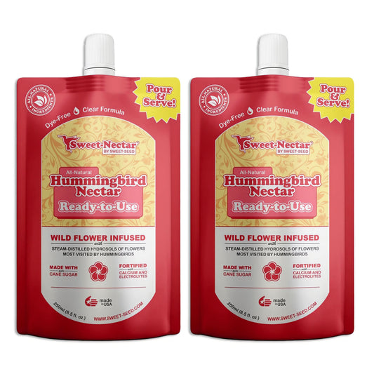 A large red bag with yellow flowers and a black spicket labels all natural hummingbird nectar ready to use