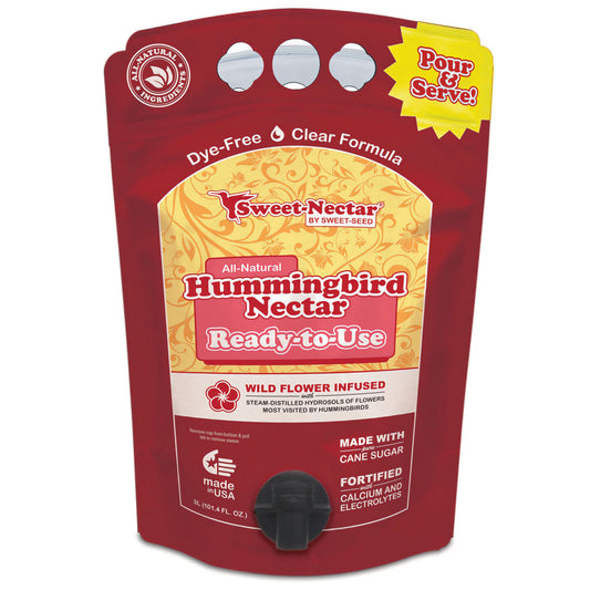 A large red bag with yellow flowers and a black spicket labels all natural hummingbird nectar ready to use